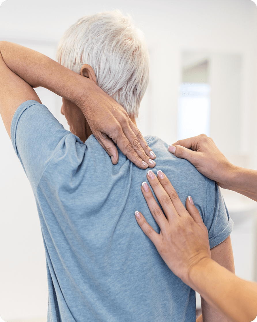 Person receiving shoulder massage for pain relief.