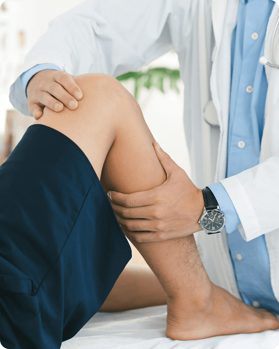 Doctor examining patient's knee.