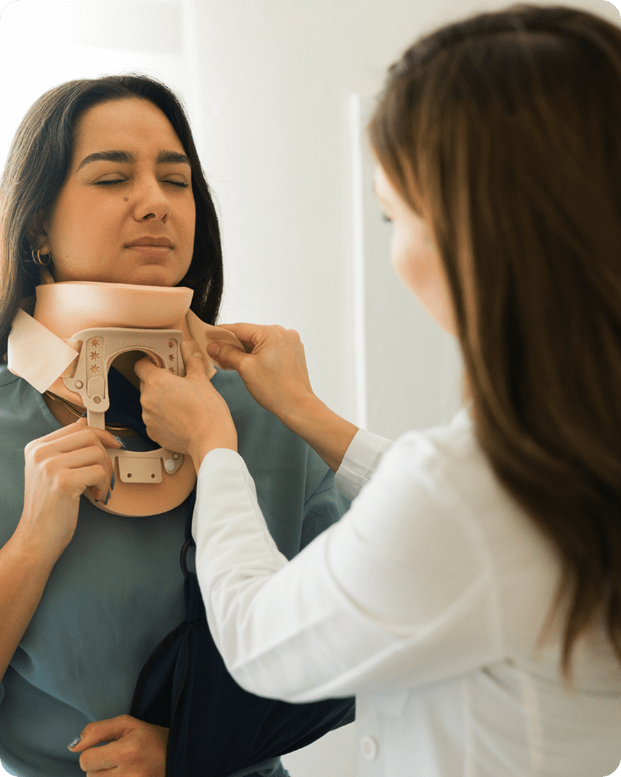 Woman assisting with neck brace adjustment.