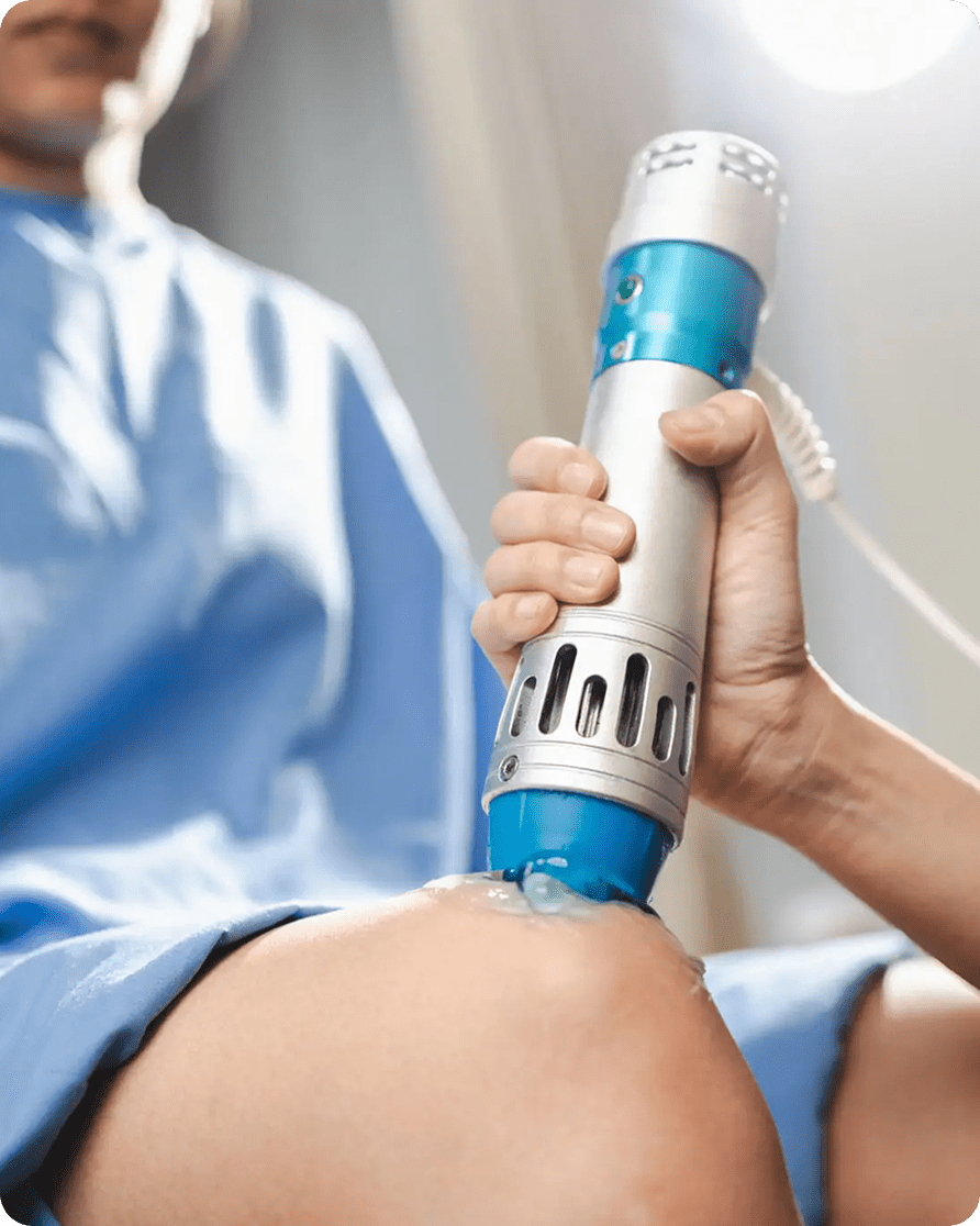 Person receiving knee treatment with device.