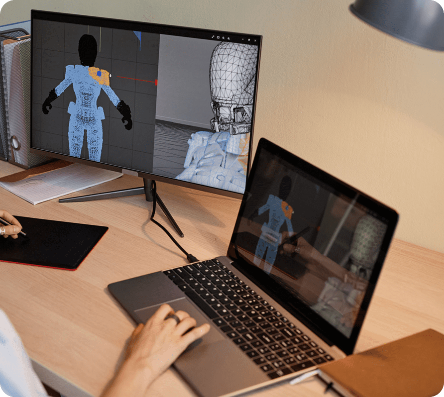 3D modeling on computer screens, person working.