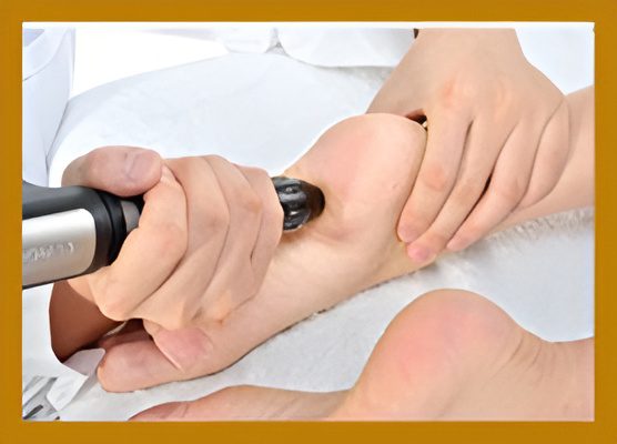 Foot massage with handheld massage device.